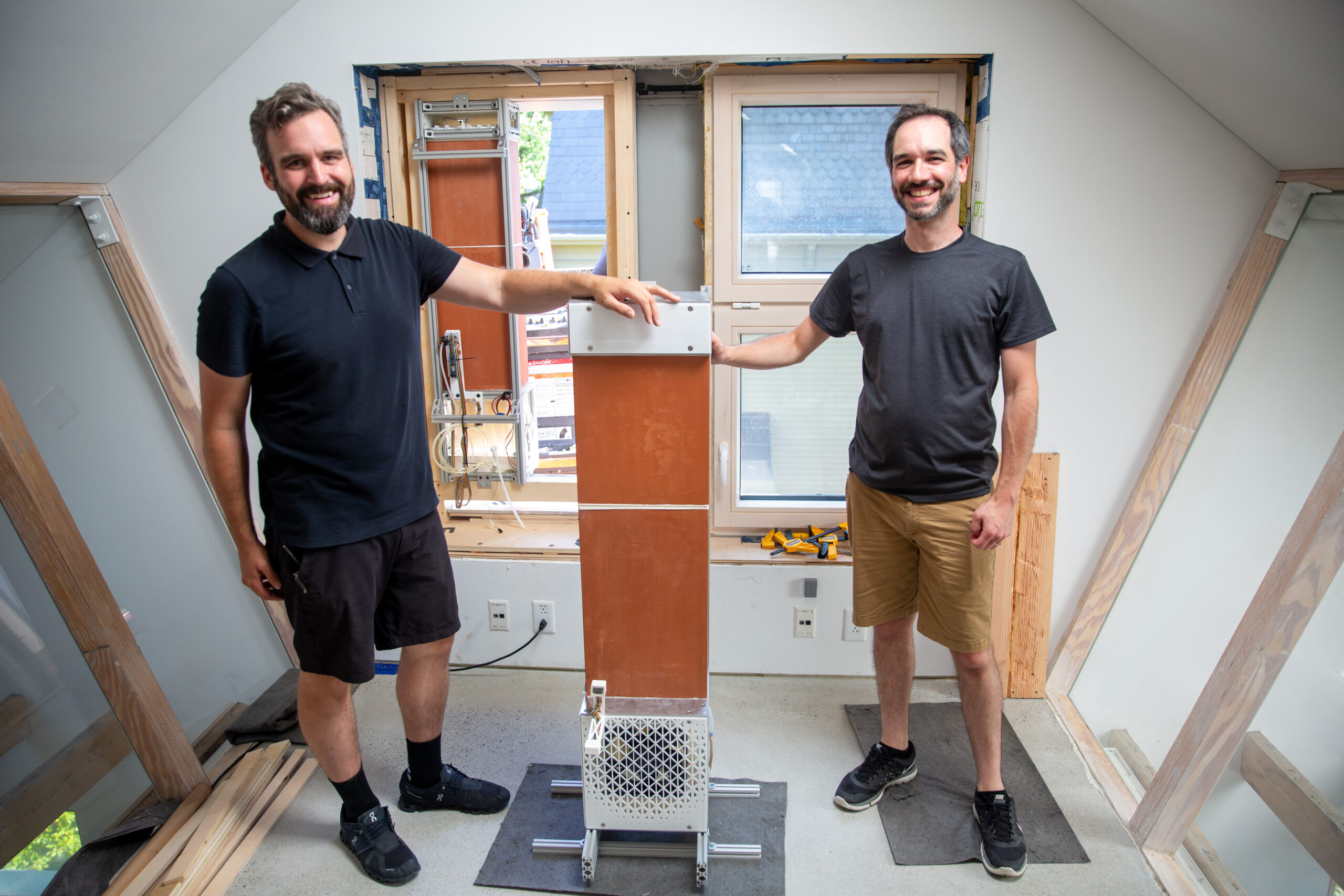 two people installing a ceramic air conditioner