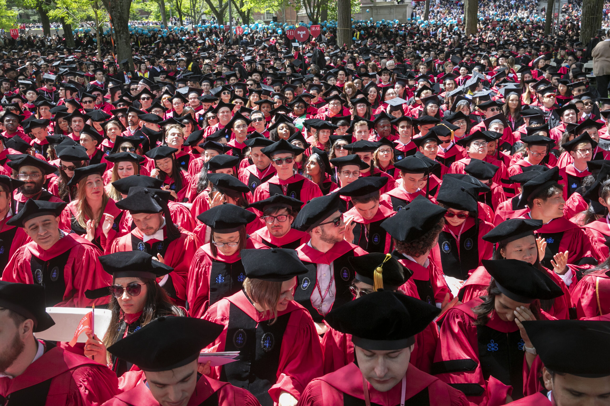 a crowd of people wearing graduation cap and gowns