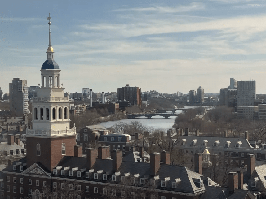 Tower with a blue dome with the Charles River in the distance.