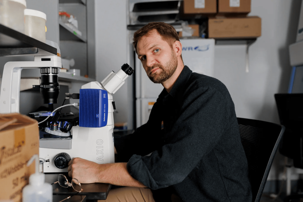 A scientist in front of a microscope