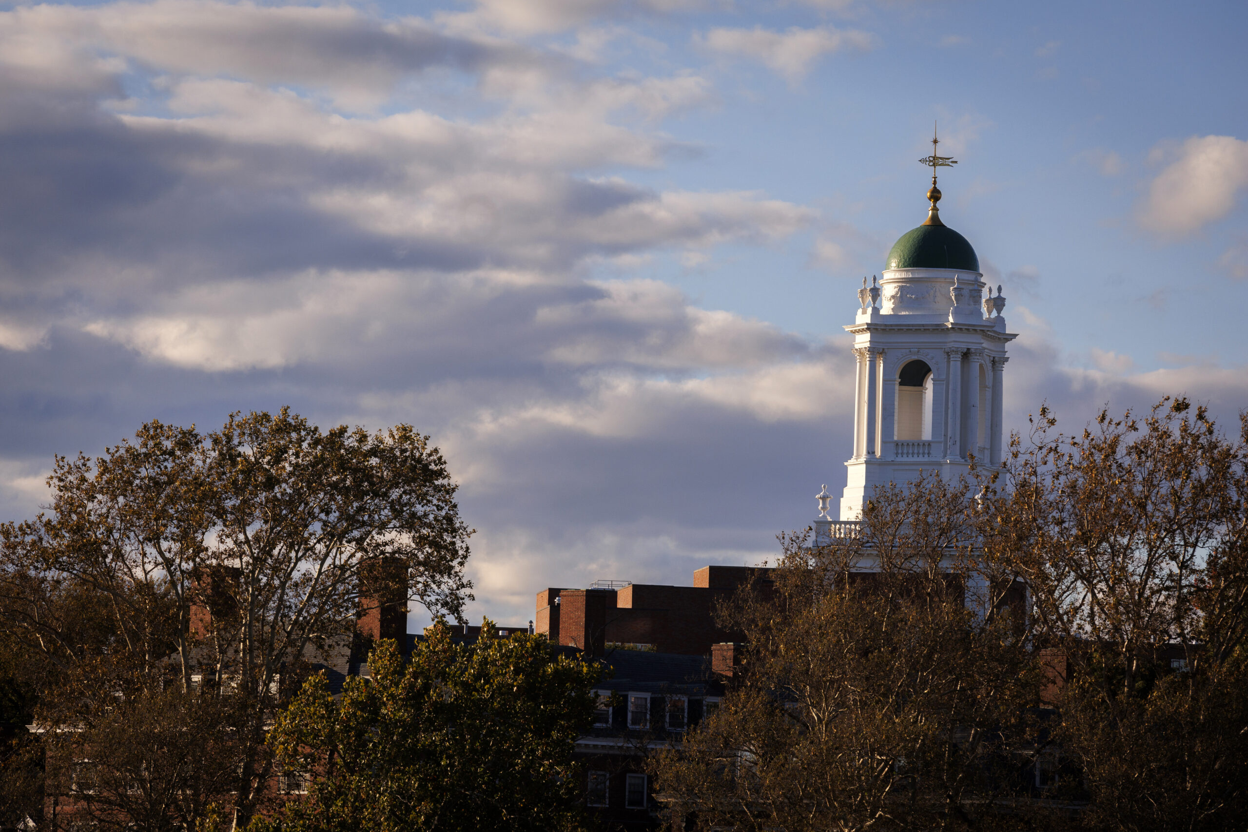 The peak of a Harvard building seen at sunset.