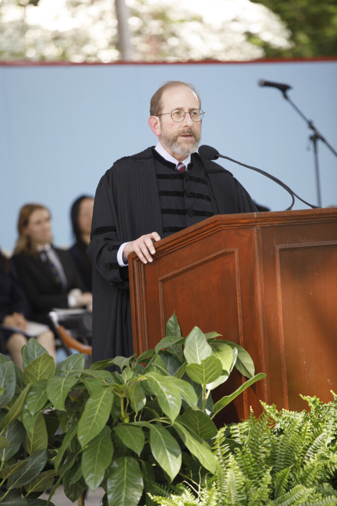 Alan Garber stands at a podium giving a speech.