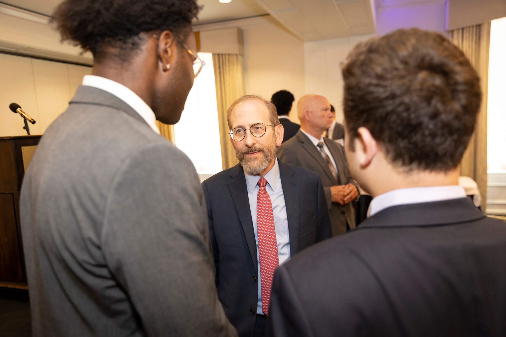 Alan Garber talking to two students