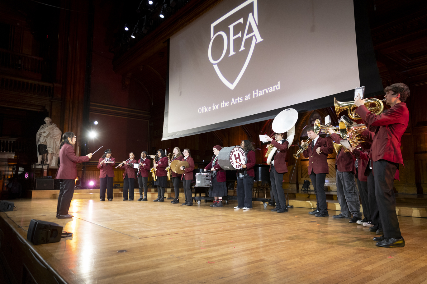 A band performs under an OFA projection.