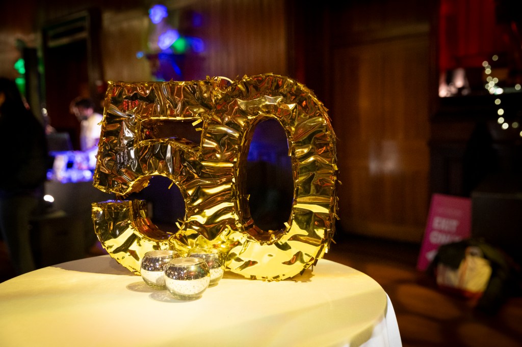 A big golden "50" decoration on a table top.