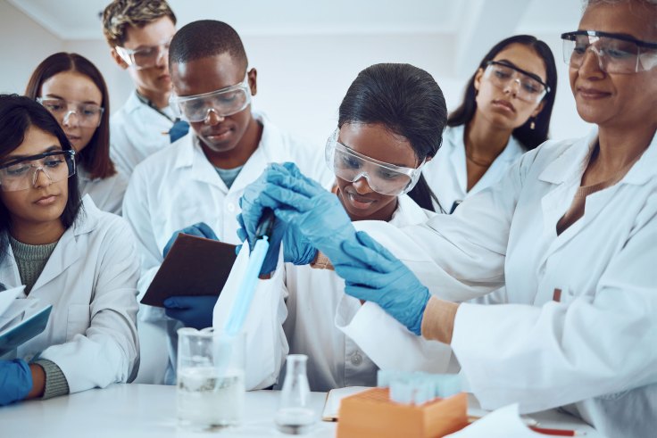 Students and teachers working in a lab