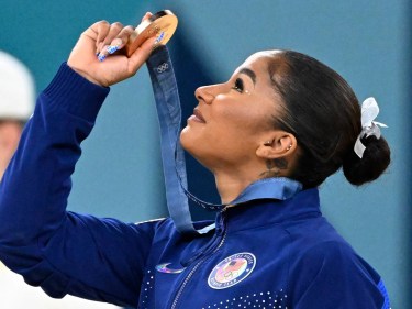 Gymnast Jordan Chiles holds up her bronze medal at the 2024 Olympic Games in Paris.