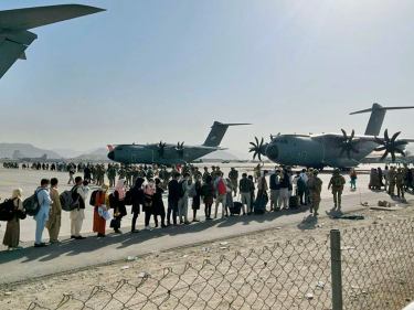 Afghan people wait at Kabul's airport.