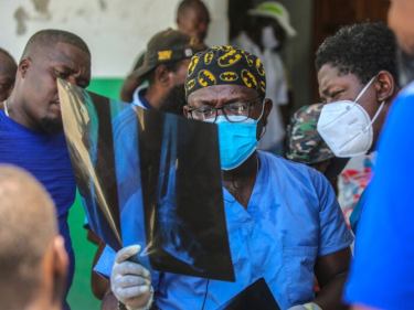 Haitian doctor looks at X-ray.