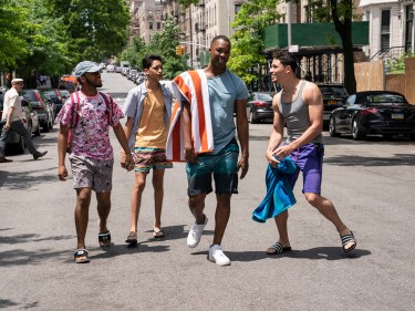 Four young men walking on a street