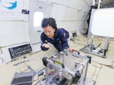 An astronaut eats pasta while floating in the spacecraft