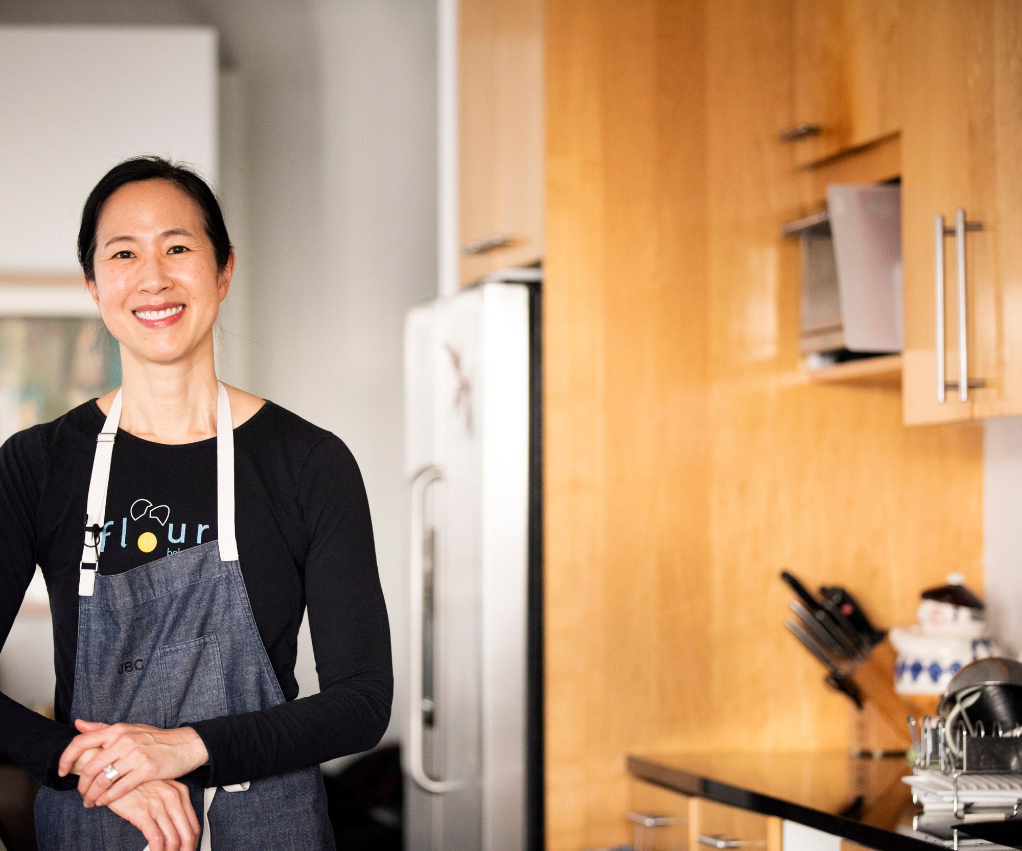 Joanne Chang wears an apron in a kitchen