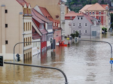 Rescue crews on a boat on a flooded street