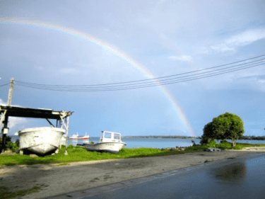 A rainbow shining over a beach