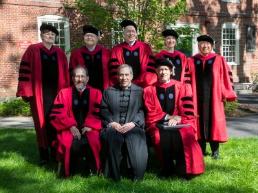 A group of people in red and black robes