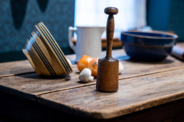 A table with a hammer, a bowl, and some food