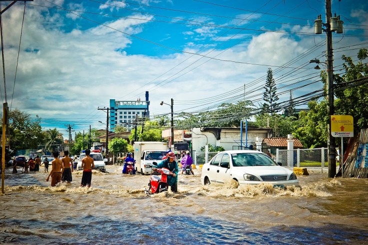 People traversing a flooded street