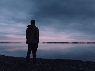 A person standing alone on a beach