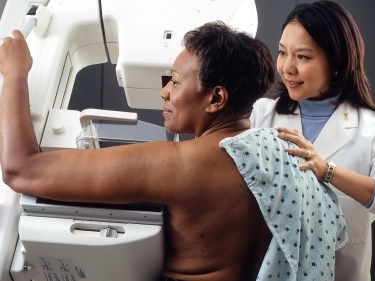 A woman getting a mammogram