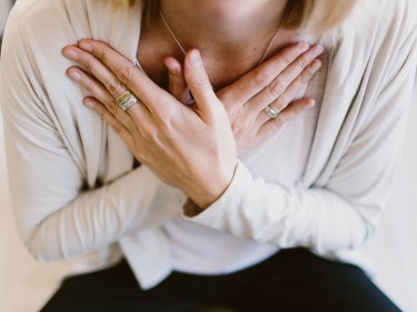 A woman with her hands crossed over her chest