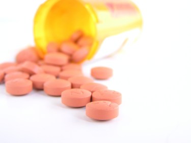 A bottle of pills being poured out