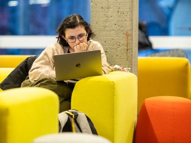 A student works on a laptop.