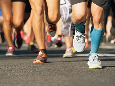 The legs of runners in a race