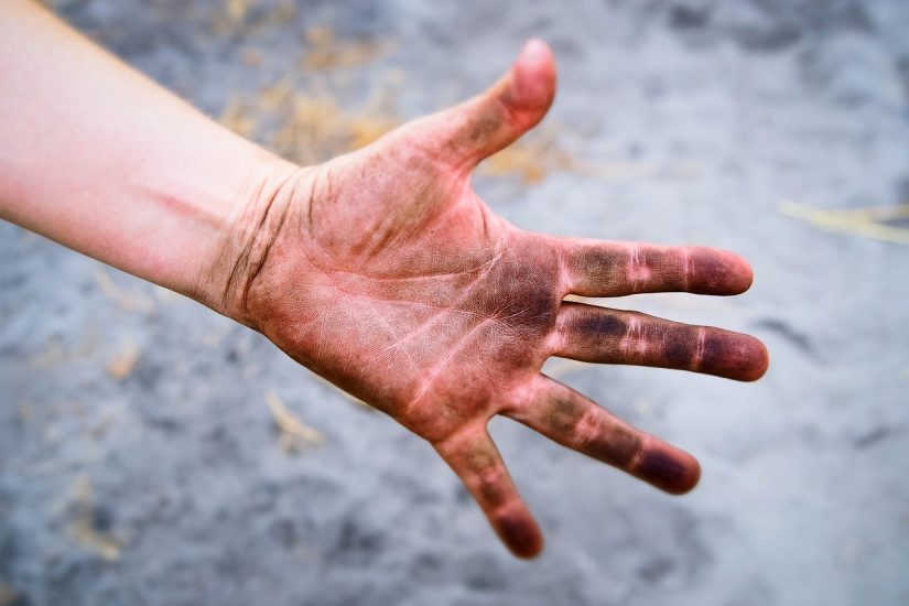 A hand covered in dirt